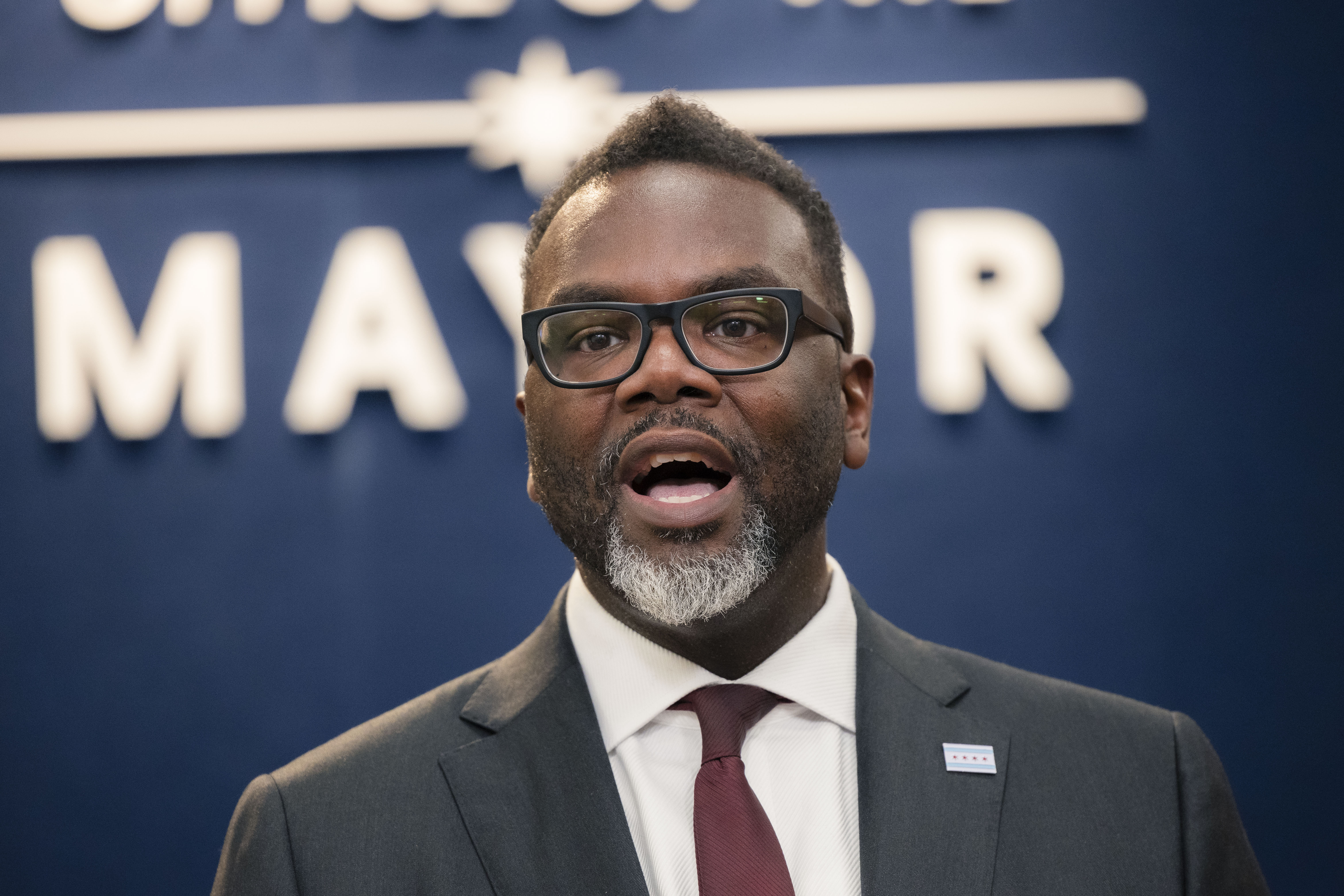 Mayor Brandon Johnson answers questions from reporters at City Hall last year.