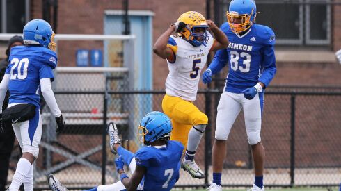 Crete-Monee’s Tyrell Hester (5) celebrates after making a big hit on Simeon’s Angelo Stockstill (7).