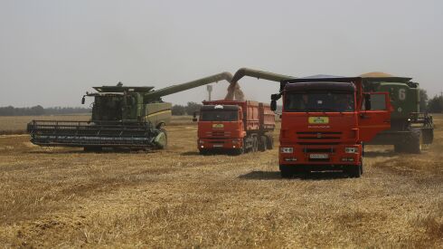 Farmers harvest with their combines in a wheat field near the village Tbilisskaya, Russia, last summer. Russia and Ukraine combine to account for about one-third of the world’s wheat and barley exports and provide large amounts of corn and cooking oils.