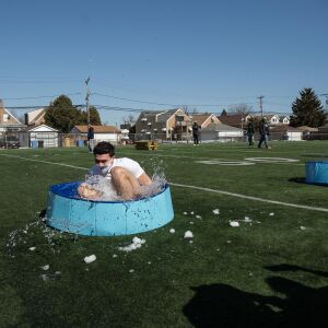A student jumps into a wading pool filled with snow and water for St. Patrick High School’s version of the Polar Plunge at St. Patrick’s High School.
