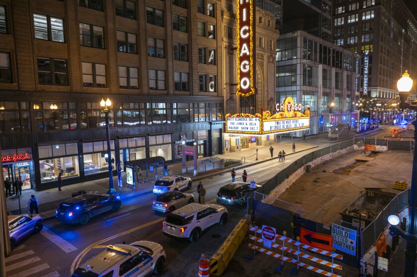 Chicago police investigate the scene where multiple people were shot outside the Chicago Theatre in The Loop, Friday, Nov. 21, 2025.