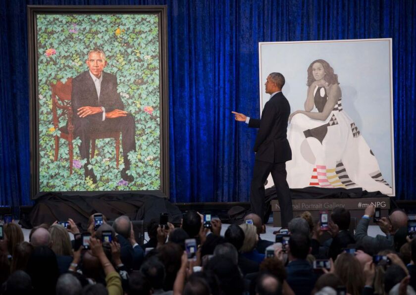 Former President Barack Obama stands before his portrait as it is unveiled alongside a portrait of former first lady Michelle Obama at the Smithsonian’s National Portrait Gallery in Washington, DC, February 12, 2018. | Getty Images