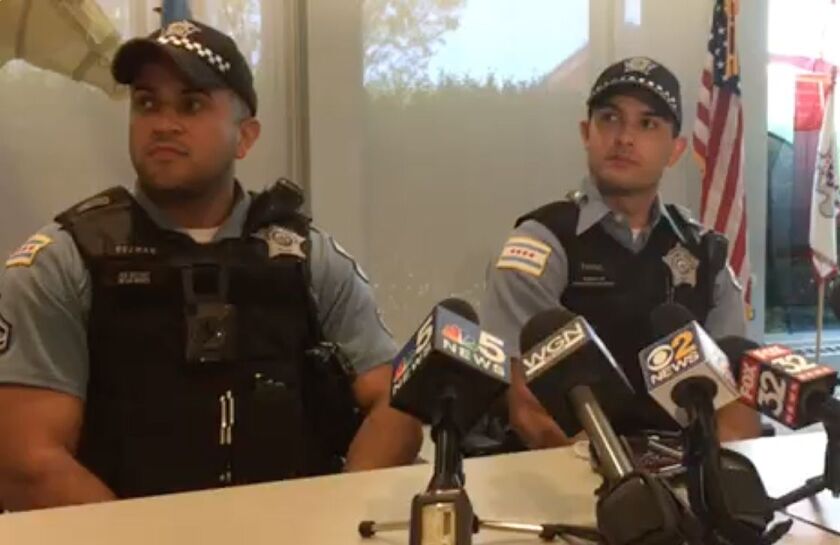 Chicago Police Field Training Officer Daniel Guzman (left) and Officer Juan Farris talk about Tuesday’s dog rescue. | Stefano Esposito/Sun-Times