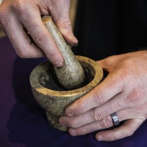 Pastor Ben Adams uses a mortar and pestle to prepare ashes for the imposition at Holy Trinity Lutheran Church in the South Loop on Ash Wednesday, Feb. 17, 2021.
