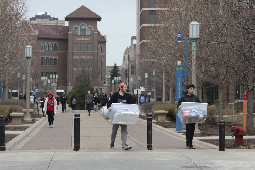 Students carry personal belongings as they moved out of the dorms at Loyola University in March, when the school had to shut down suddenly because of the coronavirus.