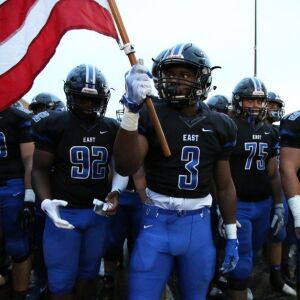 Lincoln-Way East’s A.J. Henning (3) carries the flag. Allen Cunningham/For the Sun-Times.