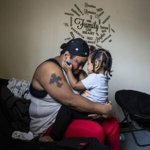 Donna Rogers, 49, plays with her 2-year-old grandson, Kayden Swann, in her daughter’s South Side apartment.
