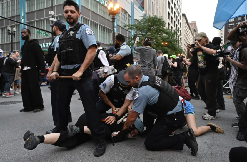 Police detain protesters during a rally and march Tuesday in the Loop. The demonstrations were in solidarity with protests in Los Angeles against ICE detentions and the Trump administration's deployment of National Guard units and Marines.