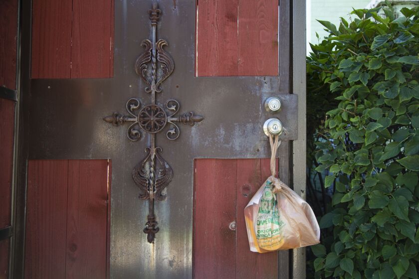 A smoke detector hangs on the door of a home in Gage Park after a fatal fire on the block in August. Chicago Fire officials were giving away the detectors in the neighborhood to remind people to keep working smoke detectors in their homes.