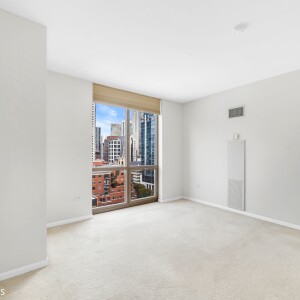 Interior of one of the bedrooms with floor-to-ceiling window