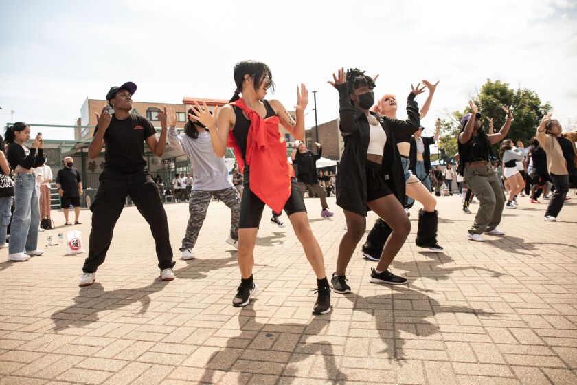 K-pop fans participate in K-Pop Random Dance, where people jump into the circle to dance together whenever they hear songs they know the choreography of, during “Youth of Chinatown,” a three-day event featuring hip-hop and K-pop performances at Chinatown Square Plaza, Saturday, Aug. 27, 2022.