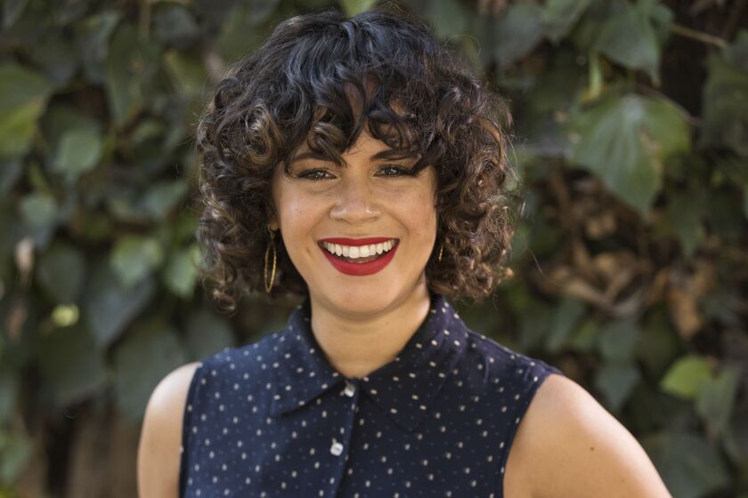 Charise Castro Smith poses for a portrait in Los Angeles to promote her Disney animated film “Encanto.” The film, which she co-directs with Jared Bush and Byron Howard, is set in Colombia and follows a teenage girl dealing with the frustration of being the only member of her family without magical powers.