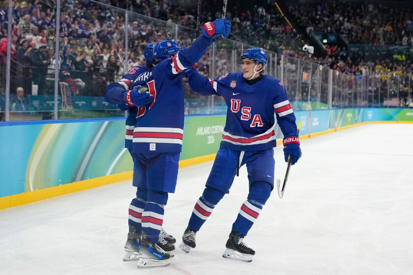 United States' Tage Thompson, right, celebrates with Dylan Larkin (21) after Larkin scored against Sweden during the second period of a men's hockey quarterfinal game at the 2026 Winter Olympics, in Milan, Italy, on Wednesday, Feb. 18, 2026.