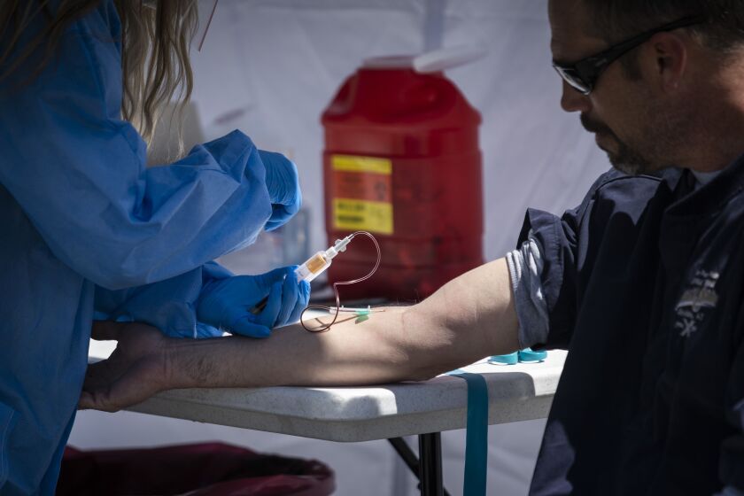 Mike Grono, 45, of Chicago’s Norwood Park neighborhood, gets his blood drawn for a coronavirus antibody test.