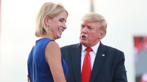 Rep. Mary Miller, R-Ill., is welcomed to the stage by Donald Trump at the Adams County Fairgrounds in Mendon, Illinois on June 25, 2022.