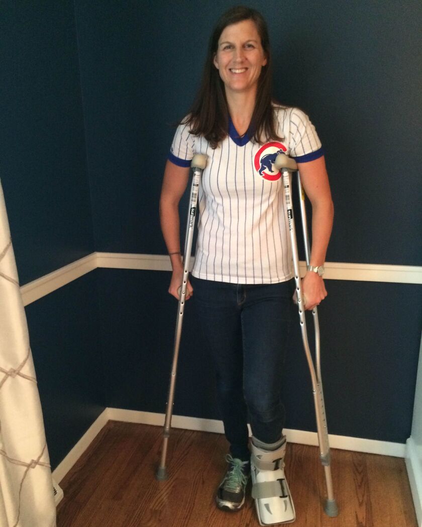 Nell Bochenek with her new protective boot and crutches for the broken foot she suffered celebrating the Cubs’ win Saturday that sent them to the World Series. | Provided photo