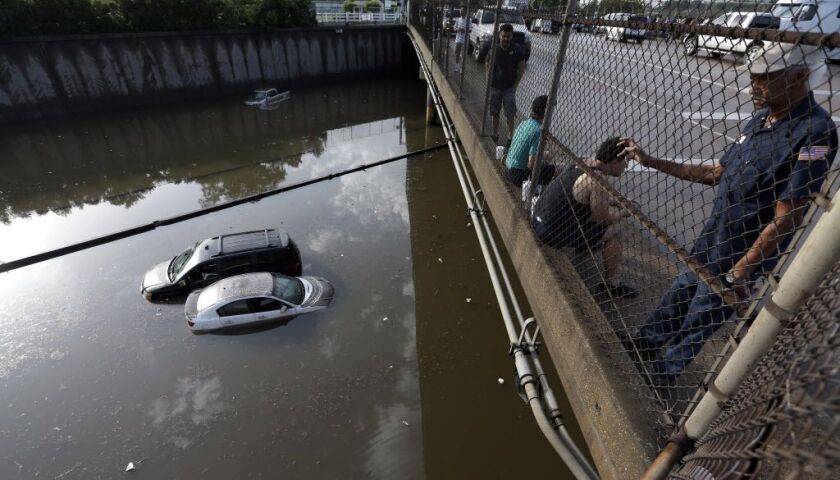 <small>Cars sit in floodwaters along Interstate 45 after heavy overnight rain flooded parts of the highway in Houston, Tuesday, May 26, 2015. Several major highways in the Houston area are closed due to high water. | David J. Phillip / AP</small>