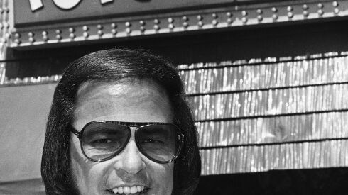 Popeyes founder Al Copeland holds a piece of his fried chicken outside one of his 34 fast food outlets in New Orleans on June 20, 1979. A new book, “Secrets of a Tastemaker: Al Copeland, The Cookbook,” released last month, helped mark the 50th anniversary of Popeyes Famous Fried Chicken.
