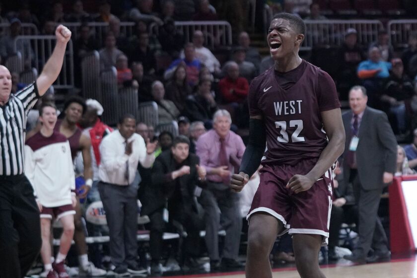 Belleville West’s EJ Liddell (32) cheers after getting a dunk late in the fourth quarter in the Class 4A state championship game.