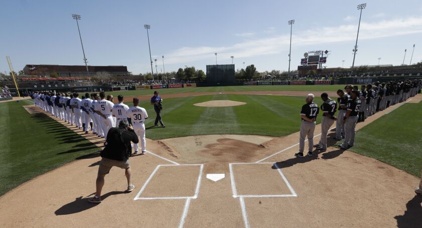 <em>Dodgers and White Sox players line up.</em>