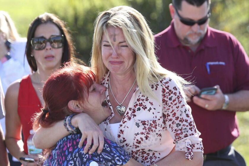 Parents wait for news after reports of a shooting at Marjory Stoneman Douglas High School in Parkland, Florida, on Wednesday, Feb. 14, 2018. | Joel Auerbach/AP photo