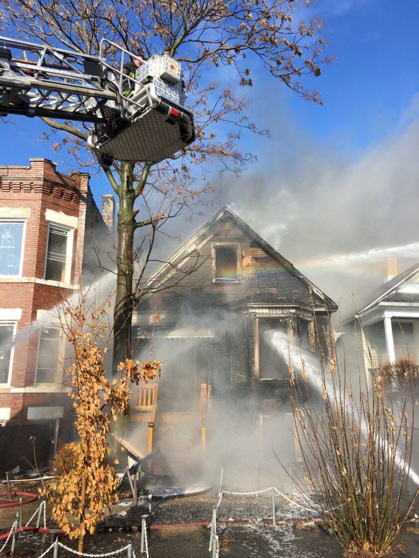 Firefighters continue battling a blaze Monday afternoon at a home in the Austin neighborhood. | Chicago Fire Media