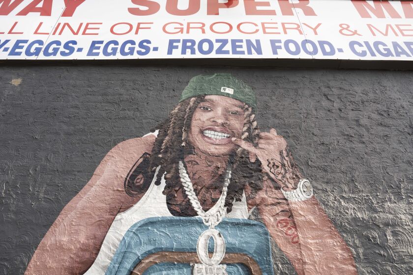 A mural of rapper King Von smiling and wearing an O Block necklace is seen at Parkway Super Market.