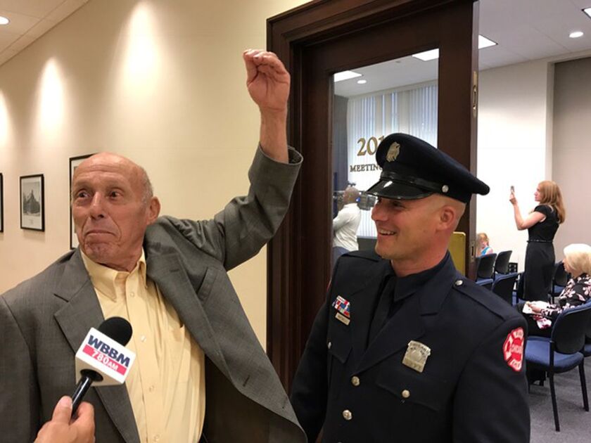 Chicago firefighter Joseph Martinelli (right) jokes with his father Robert at City Hall Thursday after receiving the Carter Harrison award, this year’s highest honor for fire bravery. | Fran Spielman/Sun-Times