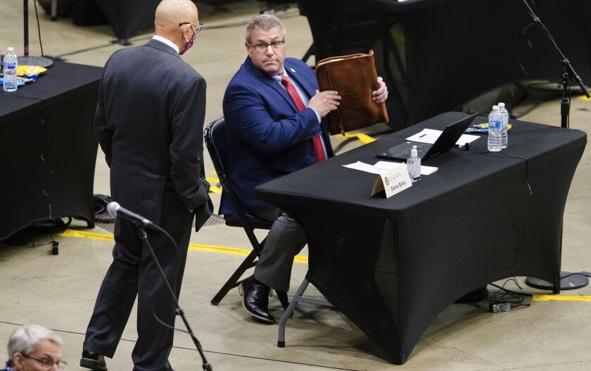 State Rep. Darren Bailey, R-Xenia, gathers things before he is escorted from the Bank of Springfield Center in Springfield,