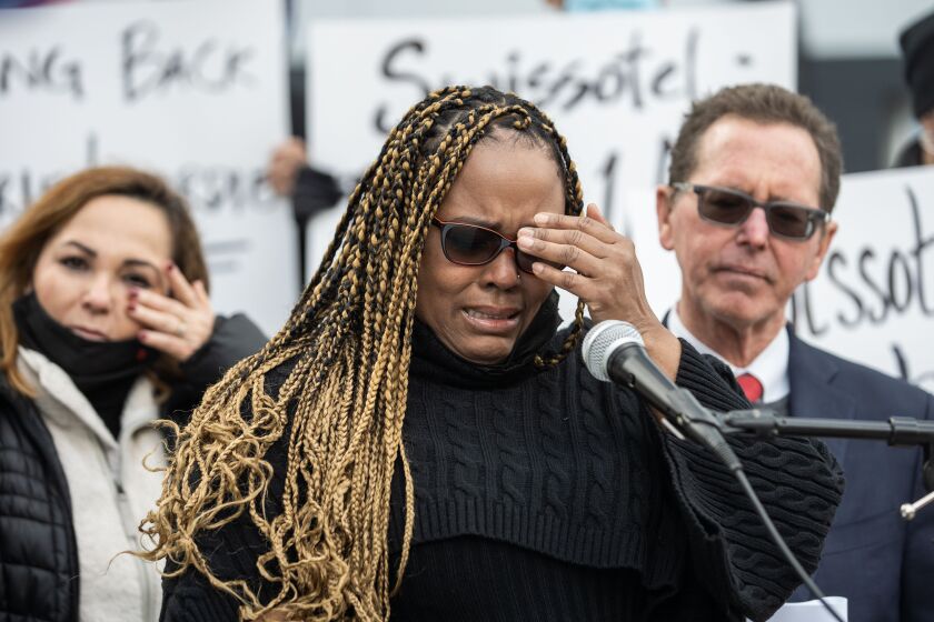 Terminated Swissotel employee Maria Lourdie Pierre-Jacques gets emotional as she speaks during a press conference outside Swissotel in the Near East Side neighborhood, Tuesday afternoon, October 26, 2021.