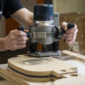 Jason Wade, lead carpenter at Pac Team, uses a template to cut plastic for face shields at the factory at 4447 W. Armitage Ave. on the Northwest Side, Tuesday afternoon, March 31, 2020.
