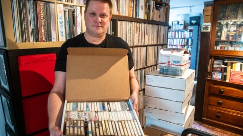 Brian Emerick holds a box of cassette tapes featuring live recordings of concerts made by Aadam Jacobs over the course of 39 years, in Aadam’s home in Hermosa, Friday, April 24, 2026. | Zubaer Khan/Sun-Times