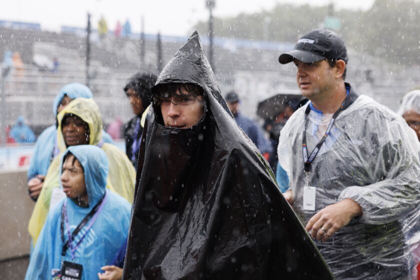 Fans endure the pouring rain prior to the Grant Park 220 NASCAR Street Race.