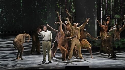 Baritone Will Liverman (left, front) is pictured with the company in a scene from the Metropolitan Opera production of “Fire Shut Up in My Bones.” Liverman will reprise his role as Charles for the Lyric Opera of Chicago.