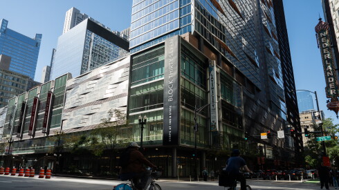 Exterior of Block 37 at 108 N. State St., with two bikers riding by.