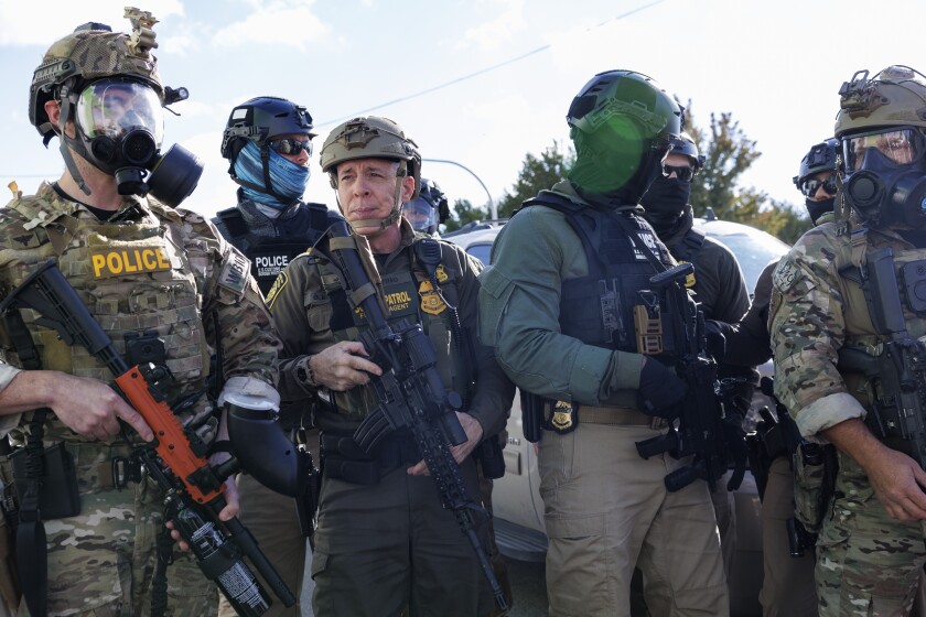 U.S. Border Patrol Commander-At-Large Gregory Bovino stands with federal immigration enforcement agents during a skirmish with protesters near West 27th Street and South Sacramento Avenue in Little Village last week.