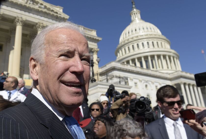Former Vice President Joe Biden pauses as he greets the crowd on Capitol Hill Wednesday after an event marking seven years since former President Barack Obama signed the Affordable Care Act into law. | Susan Walsh/Associated Press