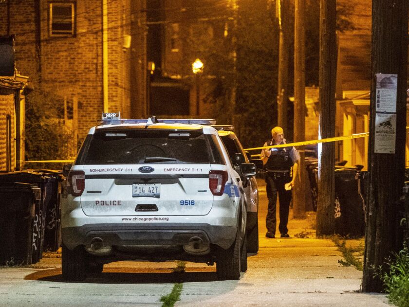 Police investigate an alley where a man was shot in the back Friday morning in the 3500 block of South Hoyne. A second scene thought to be related to this shooting was found a few block away in the 3200 block of South Hamilton. | Tyler LaRiviere/Sun-Times
