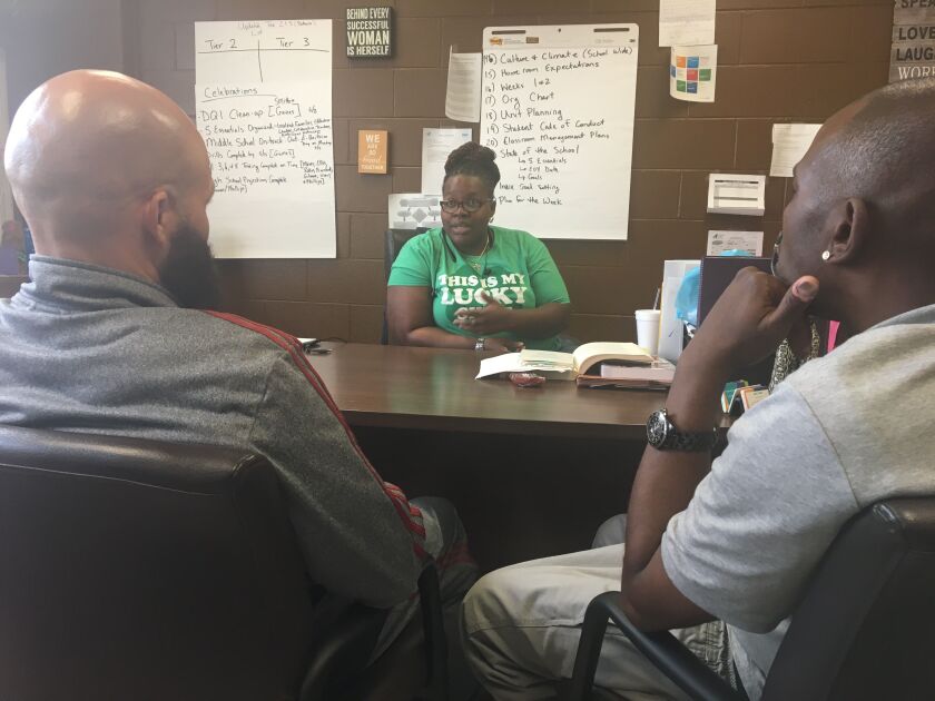 Tareef Michael (left) and Oliver “Power” Grant (right) talk with King Academy Principal Jasmine Thurmond. | provided photo