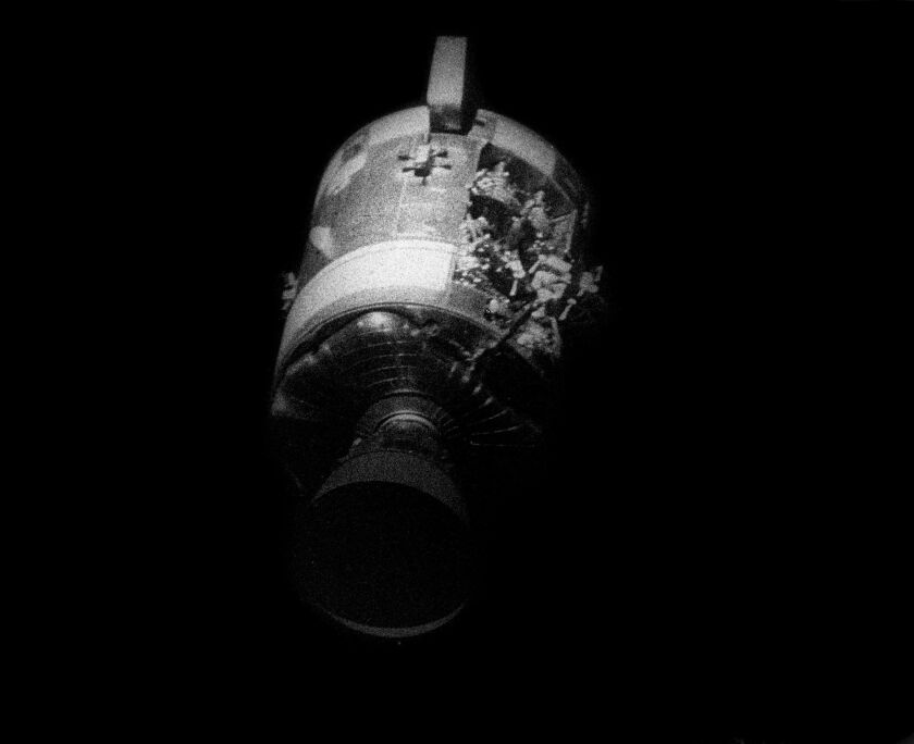 This April 17, 1970 photo made available by NASA shows the severely damaged Apollo 13 service module after separation from the lunar module/command module. An entire panel on the service module was blown away by the explosion of an oxygen tank.