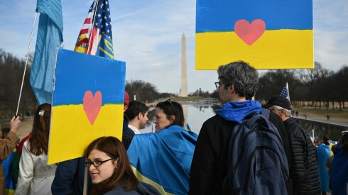 Activists hold signs as they take part in a rally to mark the fourth anniversary of Russia's war on Ukraine, at the Lincoln Memorial in Washington, DC on February 21, 2026. (Photo by Mandel NGAN / AFP via Getty Images)