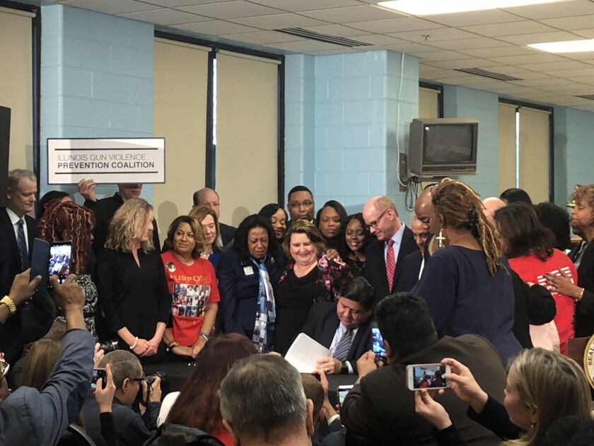 J.B. Pritzker signs gun control legislation at Ella Flagg Young Elementary School on the West Side. | Tina Sfondeles for the Sun-Times
