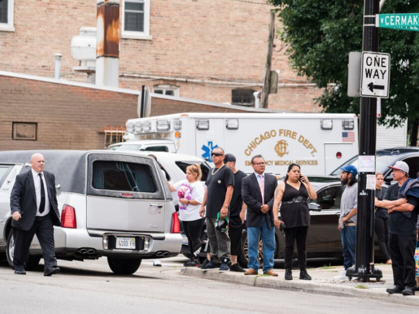 Family and friends of the fire victims stand outside Our Lady Of Tepeyac church after a funeral on Sept. 1. | Max Herman/For the Sun-Times