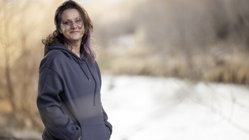 Lottie Elliott, who says she has benefited from the Bridges of Colorado program, stands near the spot where she spent her first night homeless in Monument Valley Park in Colorado Springs, Monday, Feb. 23, 2026. | Kevin Mohatt/For the Sun-Times