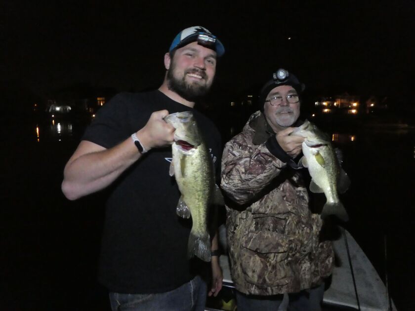Ryan Baranowski (left) and Dale Bowman show off a double catch of largemouth bass on a night outing last weekend.<br>Provided by Dave Holmquist