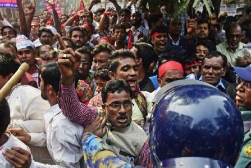 Bangladesh police stop activists from the Road Transport League, a wing of the ruling Bangladesh Awami League as they protest against the on-going nationwide strike outside the Bangladesh Nationalist Party office in Dhaka on February 9, 2015. MUNIR UZ ZA
