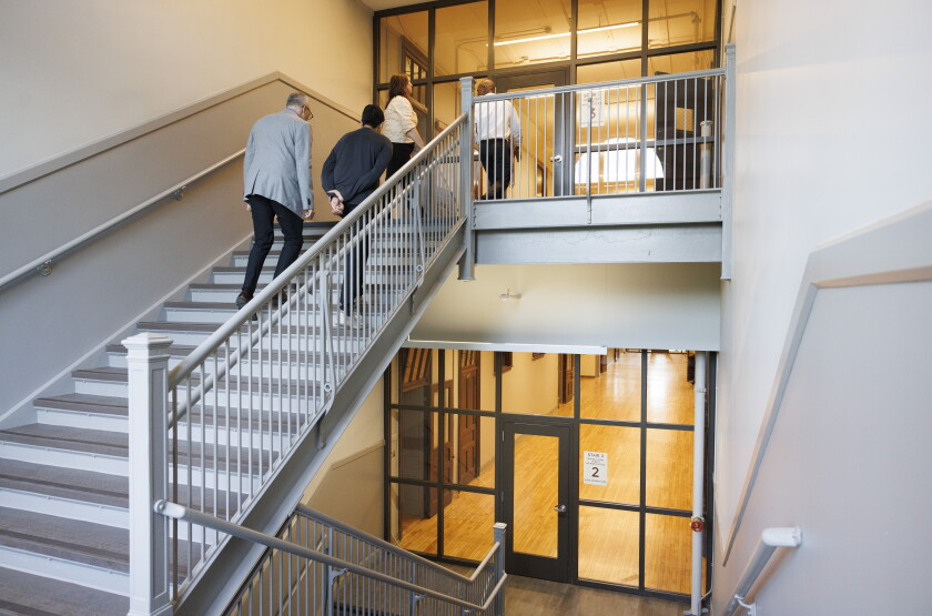 Visitors tour the Earle Residences during the project's ribbon cutting ceremony.