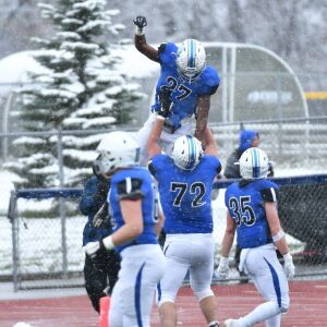 St. Charles North’s Alex Westendorf lifts up Tyler Nubin (27). Worsom Robinson/For the Sun-Times.