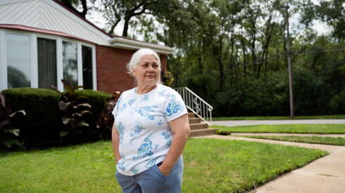 Andrea Martin outside her homed on Aug. 12, 2026. Her home is separated from Pullman Innovations by an overgrown lot, in South Deering.
