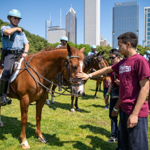 Students pet a Chicago Police Department horse at the All-Star Fest.